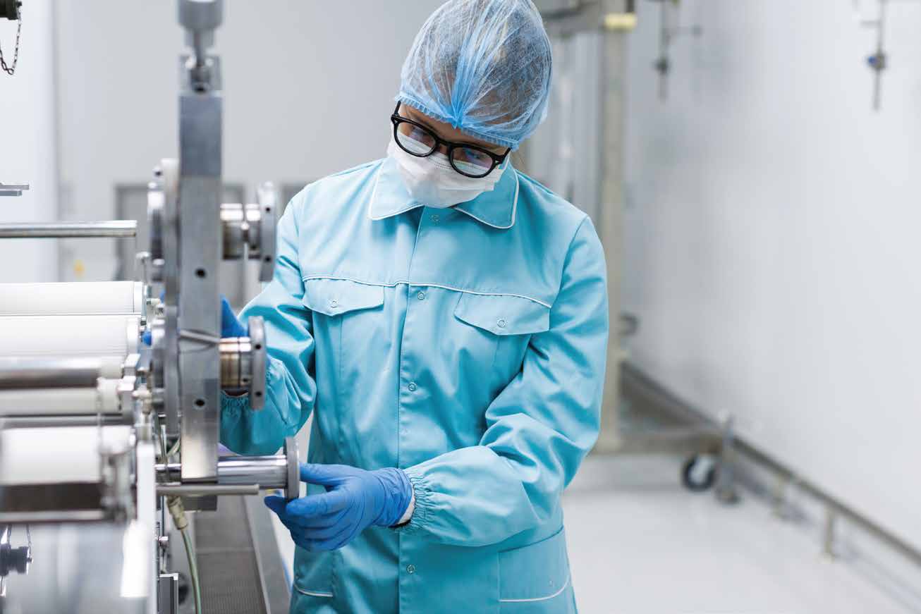 Production equipment and a worker in protective clothing